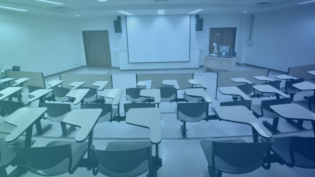 company board room with desks and chairs with an audio visual system installed